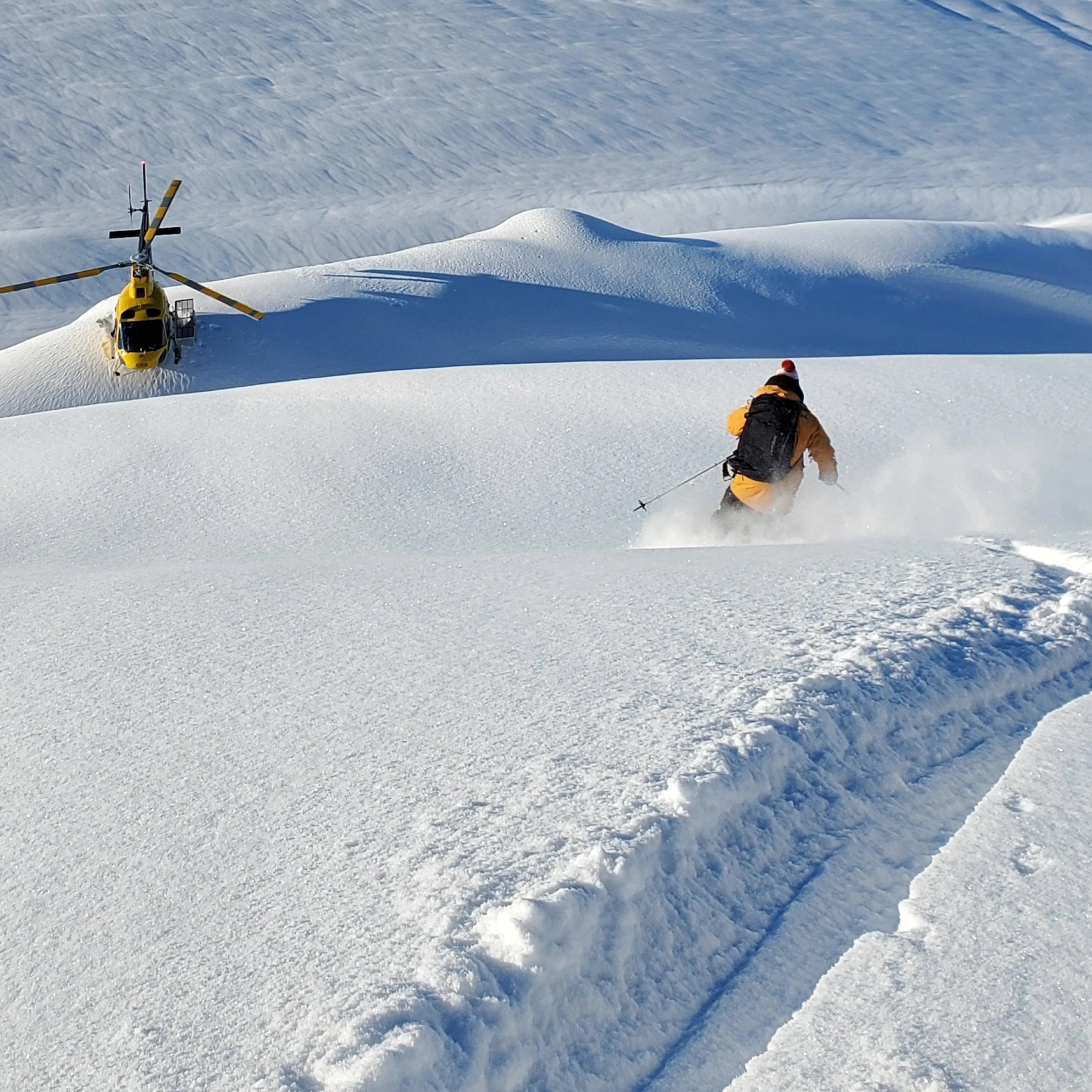 SMG heli skier and helicopter in the Northern Chugach